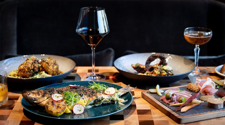 FIA Grilled Whole Branzino, Blue Ridge Farm Cauliflower Steak, Charred Octopus, and House Charcuterie. Photo credit- Mia Yakel.