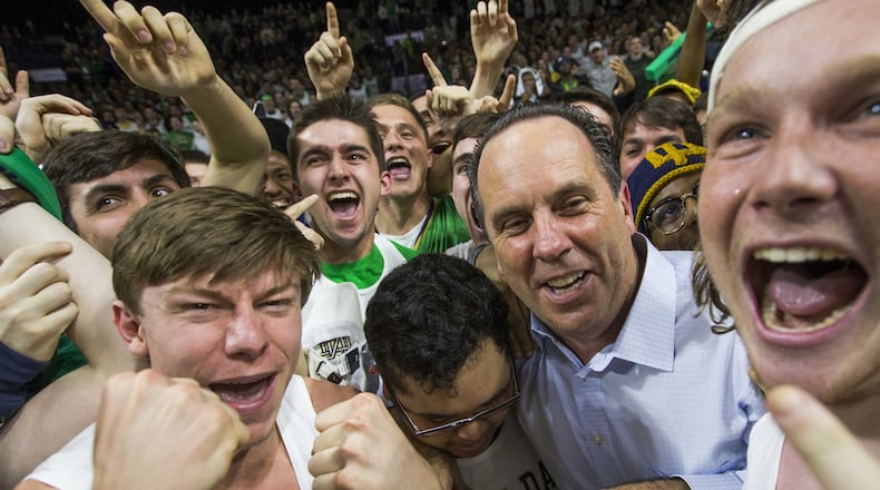 Notre Dame coach Mike Brey celebrates in the Notre Dame student section following his team’s game against Florida State on Saturday, Feb. 11, 2017, in South Bend, Ind. Notre Dame won 84-72. (AP Photo/Robert Franklin)