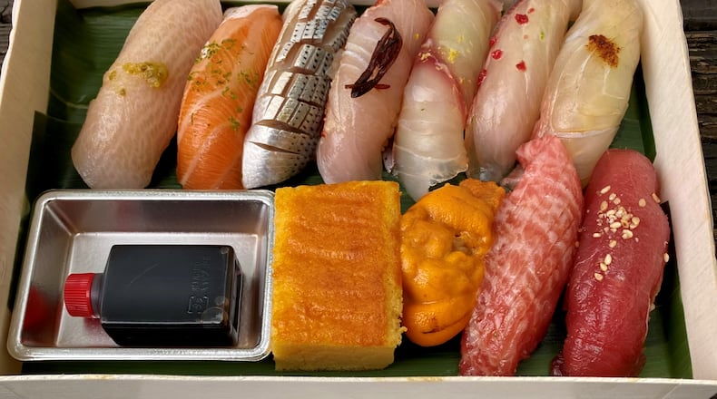 Mujo, currently operating out of Cooks & Soldiers until its permanent home next door is ready, offers an exquisite to-go nigiri set for $65, including soup (not shown). (Wendell Brock for The Atlanta Journal-Constitution)