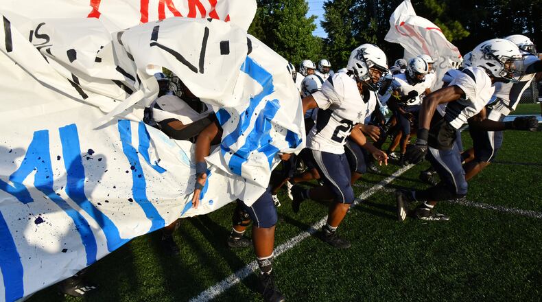August 26 , 2022 Norcross - South Gwinnett players break their cheerleader banner before their football game against Meadowcreek at Meadowcreek High School in Norcross on Friday, August 26, 2022. (Hyosub Shin / Hyosub.Shin@ajc.com)
