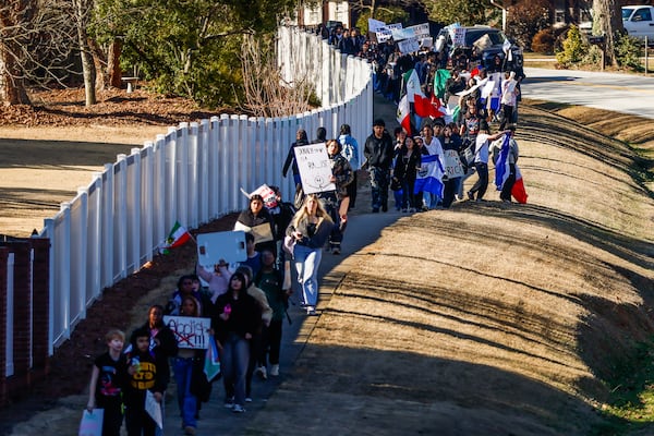 Brookwood High School students march down Dogwood Road in Snellville as they rally against ICE on Wednesday. (Abbey Cutrer/AJC)