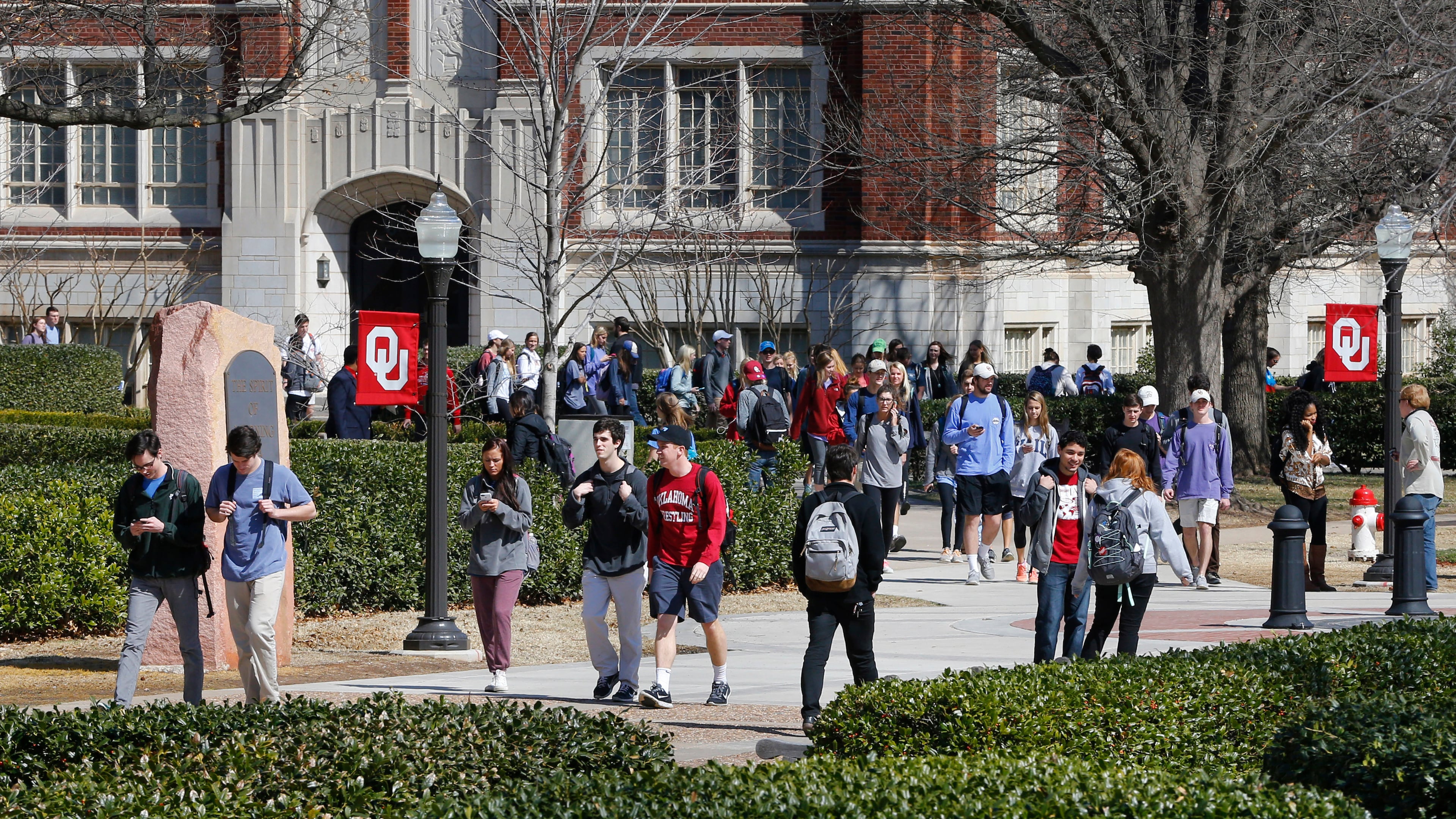 FILE - People walk on the Oval at the University of Oklahoma in Norman, Okla., Tuesday, March 10, 2015. (AP Photo/Sue Ogrocki, File)