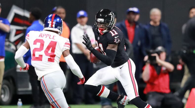 10/22/18 - Atlanta - Atlanta Falcons wide receiver Julio Jones (11) runs for a first down on the opening drive of the Falcons agains defender New York Giants cornerback Eli Apple (24).  The Atlanta Falcons played the New York Giants in an NFL football game Monday, October 22, 2018, at Mercedes-Benz Stadium in Atlanta, GA.     CURTIS COMPTON  / CCOMPTON@AJC.COM