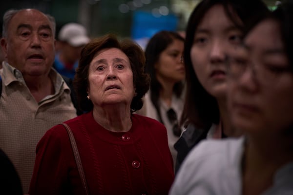 Passengers react as they wait for news of train departures, at Sants train station in Barcelona, Spain, Tuesday, April 29, 2025. (AP Photo/Emilio Morenatti)