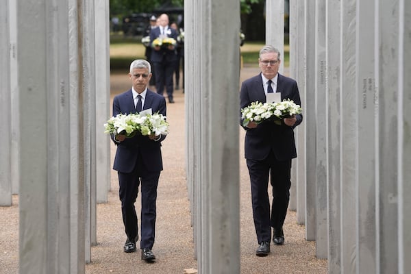 Mayor of London Sadiq Khan, left, and Britain's Prime Minister Keir Starmer lay a wreath at the 7/7 Memorial, in Hyde Park to mark the anniversary of the terrorist attacks in London July 7, 2005 that killed 52 people, in London, Monday July 7, 2025. (Stefan Rousseau/PA via AP)