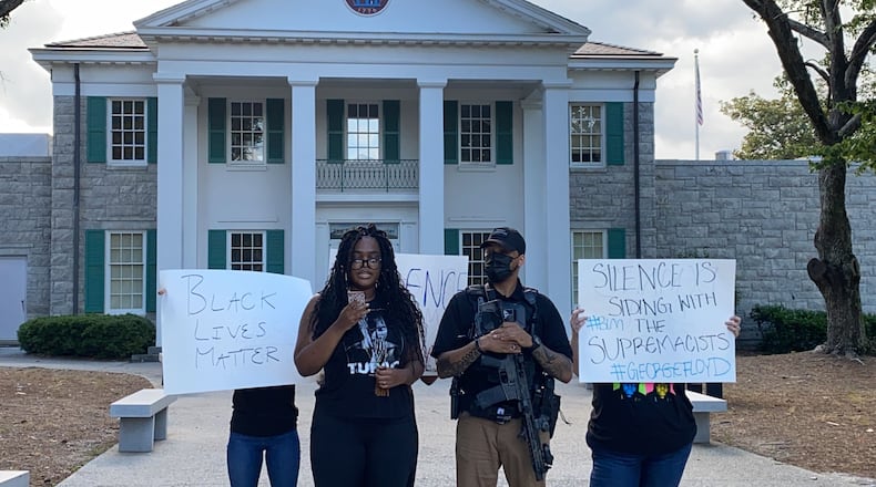 Zoe Bambara stands in front of Confederate Hall at Stone Mountain Park with a modest few people and broadcasts her speech via Instagram live on Thursday, June 4, 2020. (Photo: Special to the AJC)