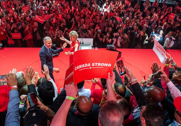 Canadian Prime Minister Mark Carney and his wife Diana Fox Carney react on stage at his campaign headquarters after the Liberal Party won the Canadian election in Ottawa on Tuesday, April 29, 2025. (Frank Gunn/The Canadian Press via AP)