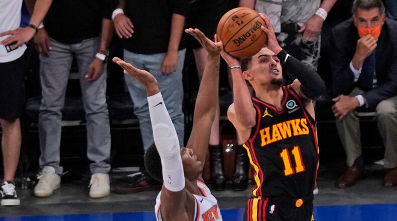 New York Knicks' RJ Barrett (left) fouls Atlanta Hawks' Trae Young during the second half of Game 1 of first-round playoff series, Sunday, May 23, 2021, in New York. The Hawks won 107-105. (Seth Wenig/AP)