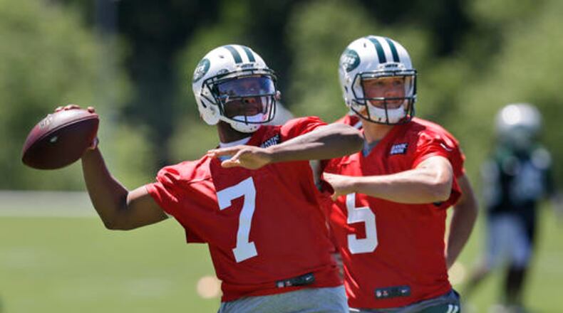 New York Jets quarterbacks Geno Smith, left, and Christian Hackenberg look to throw during NFL football practice in Florham Park, N.J., Wednesday, June 15, 2016. (AP Photo/Seth Wenig)