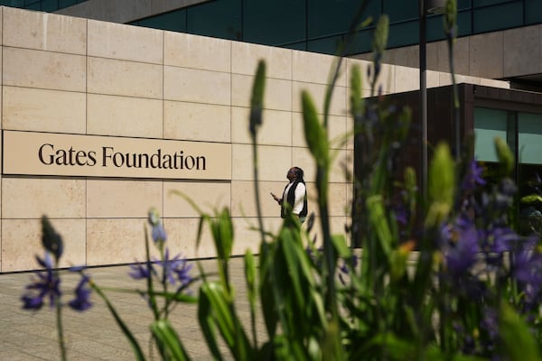 A person walks outside of the Gates Foundation campus Wednesday, April 30, 2025, in Seattle. (AP Photo/Lindsey Wasson)