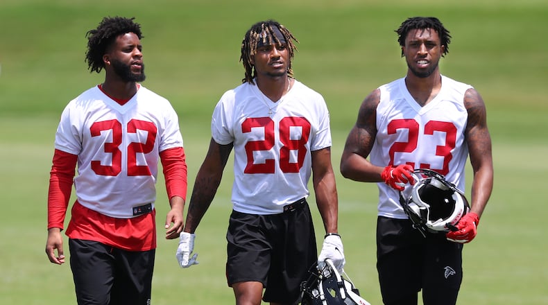 Falcons cornerbacks (from left) Rashard Causey, Jordan Miller and Jayson Stanley walk off the field at the end of team practice. Curtis Compton/ccompton@ajc.com