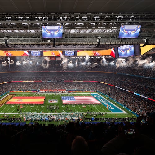 An overall, interior, general view of the Santiango Bernabeu stadium during the singing of the national anthems before an NFL football game between the Miami Dolphins and the Washington Commanders in Madrid, Spain, Sunday, Nov. 16, 2025. (AP Photo/Manu Reino)