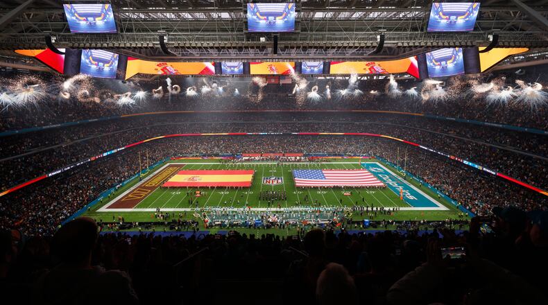 An overall, interior, general view of the Santiango Bernabeu stadium during the singing of the national anthems before an NFL football game between the Miami Dolphins and the Washington Commanders in Madrid, Spain, Sunday, Nov. 16, 2025. (AP Photo/Manu Reino)