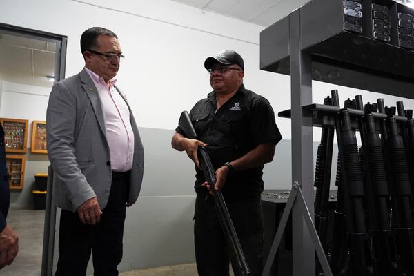 Costa Rica's Justice and Peace Minister Gerald Campos Valverde, left, tours the armory at the Terrorist Confinement Center in Tecoluca, El Salvador, Friday, April 4, 2025. (AP Photo/Salvador Melendez)