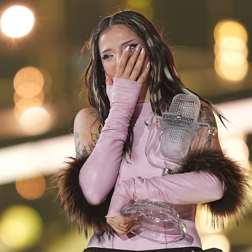 Dara from Bulgaria reacts as she holds the trophy after winning the Grand Final of the 70th Eurovision Song Contest in Vienna, Austria, Sunday, May 17, 2026. (AP Photo/Martin Meissner)