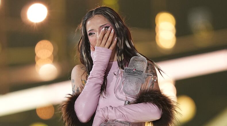 Dara from Bulgaria reacts as she holds the trophy after winning the Grand Final of the 70th Eurovision Song Contest in Vienna, Austria, Sunday, May 17, 2026. (AP Photo/Martin Meissner)