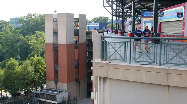 A baseball fan fell from the upper deck at Turner Field stadium (near the red sign at the top of a stairwell at far left) near the edge of the player's parking lot (bottom left) during the game last night as fans begin to arrive for today's game at Turner Field on Tuesday Aug. 13, 2013 in Atlanta.