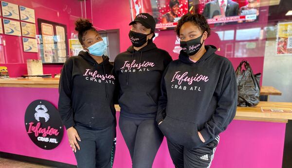 Infusion Crab ATL opened in September in Marietta and is owned and operated by Kimberly Knox (center) and her daughters McKenzie (left) and Madison. 
Wendell Brock for The Atlanta Journal-Constitution