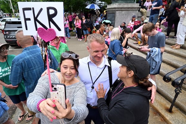 Blogger Aidan Kearney, center, meets with fans and Karen Read supporters, from left, Linda Allen of Rockland, MA, and Shannon LoPorto of Weymouth, MA, outside the Dedham, Mass. courthouse on the third day of jury deliberations in Read's trial at Norfolk Superior Court, Wednesday, June 18, 2025, in Dedham, Mass. (AP Photo/Josh Reynolds)