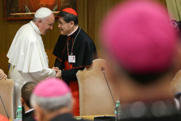 FILE - In this Monday, Oct. 5, 2015 file photo, Pope Francis is greeted by Cardinal Luis Antonio Tagle, right, upon his arrival at the opening session of a two-week bishops' meeting on family issues, at the Vatican. (AP Photo/Alessandra Tarantino, File)