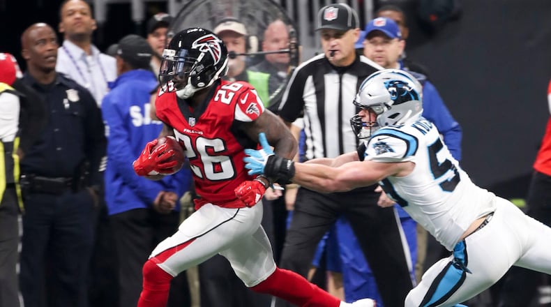 Atlanta Falcons running back Tevin Coleman (26) carries the ball down the field during the first quarter of the game against the Carolina Panthers at Mercedes Benz Stadium, Sunday, December 31, 2017. ALYSSA POINTER/ALYSSA.POINTER@AJC.COM