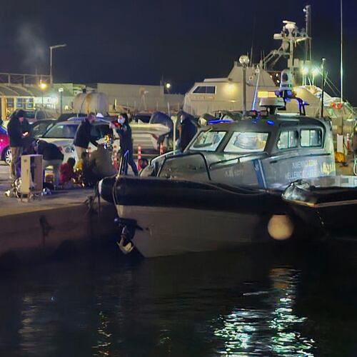 Greek coast guard officers carry out rescue operations at a port on the eastern Aegean island of Chios, Greece, late Tuesday, Feb. 3, 2026, after a collision between a migrant speedboat and a coast guard patrol vessel killed multiple people, authorities said. (Pantelis Fykaris/Politischios.gr via AP)