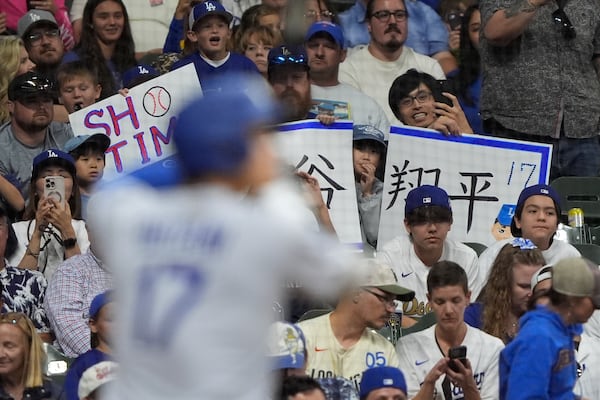 Fans cheer as Los Angeles Dodgers' Shohei Ohtani bats during the eighth inning of a baseball game against the Milwaukee Brewers, Monday, July 7, 2025, in Milwaukee. (AP Photo/Aaron Gash)