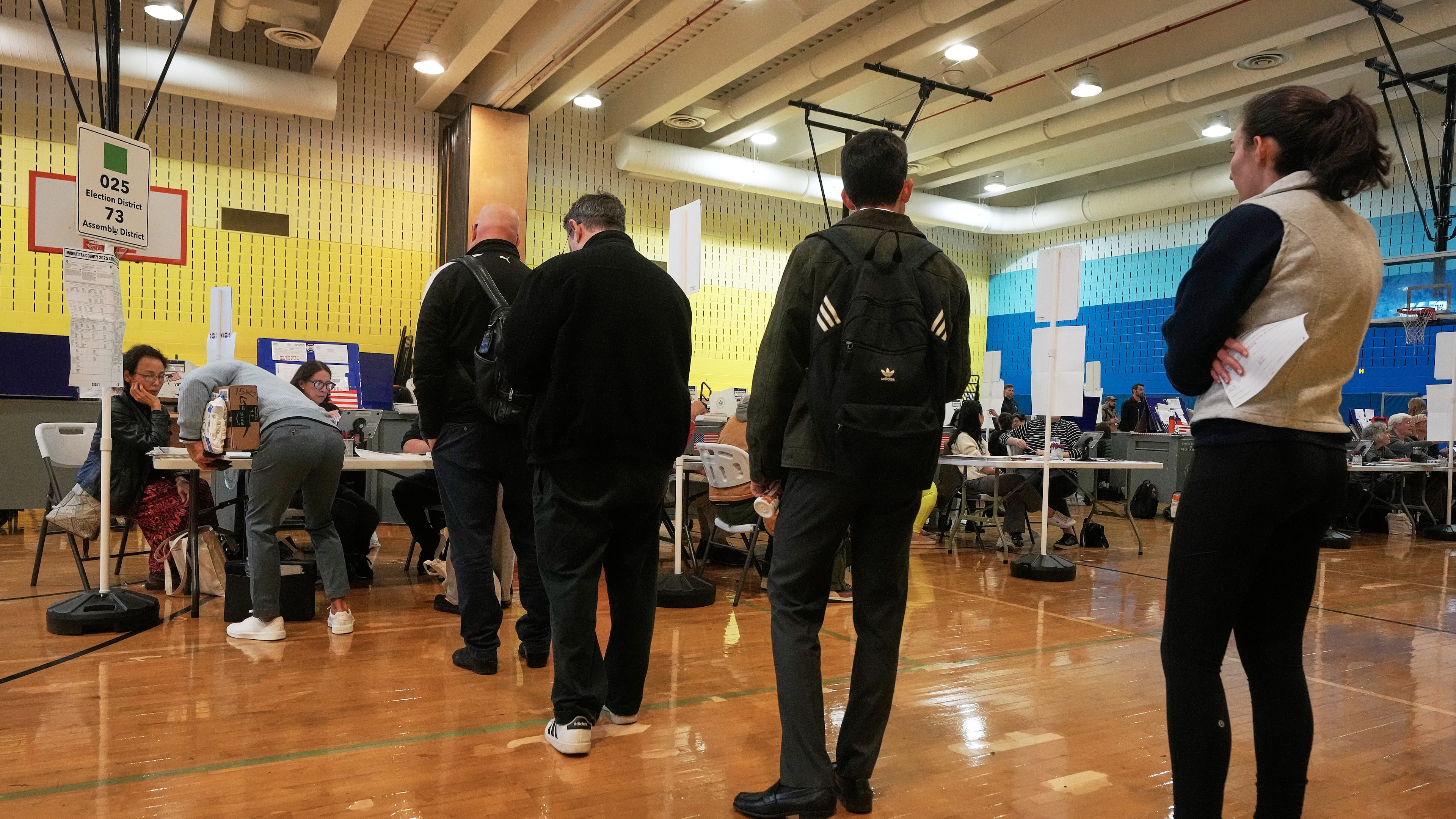 Voters sign-in at a polling site, in New York, Tuesday, Nov. 4, 2025. (AP Photo/Richard Drew)
