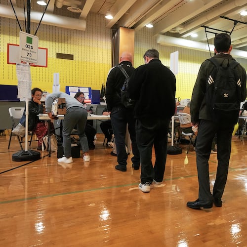 Voters sign-in at a polling site, in New York, Tuesday, Nov. 4, 2025. (AP Photo/Richard Drew)