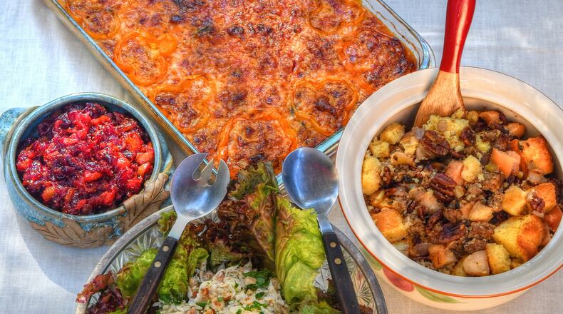 The AJC's food writers have some suggestions for your Thanksgiving table, including Cheesy Squash Casserole (top), Cranberry-Fig Chutney (center left), Sausage and Apple Cornbread Dressing (center right) and Iris’s Celery Root, Apple, and Hazelnut Salad (bottom). Styling by Ligaya Figueras / Chris Hunt for the AJC