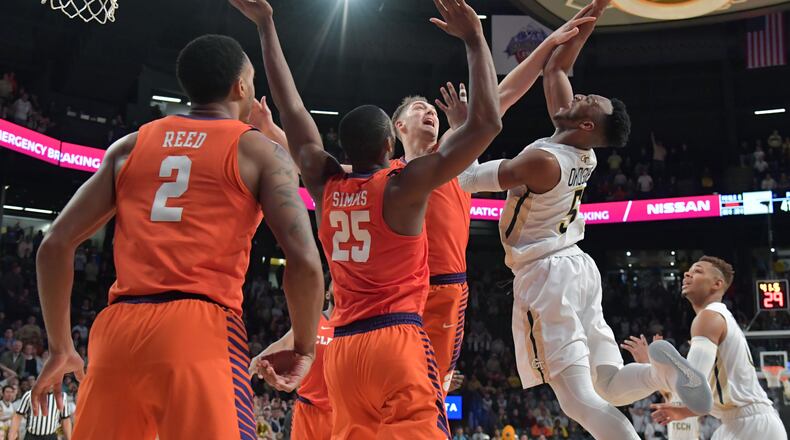 January 28, 2018 Atlanta - Georgia Tech guard Josh Okogie (5) gets a shot off against Clemson forward Aamir Simms (25) and Clemson forward Mark Donnal (5) during the second in a NCAA college basketball game at McCamish Pavilion in Atlanta on Sunday, January 28, 2018. Clemson won 72-70 over the Georgia Tech. HYOSUB SHIN / HSHIN@AJC.COM