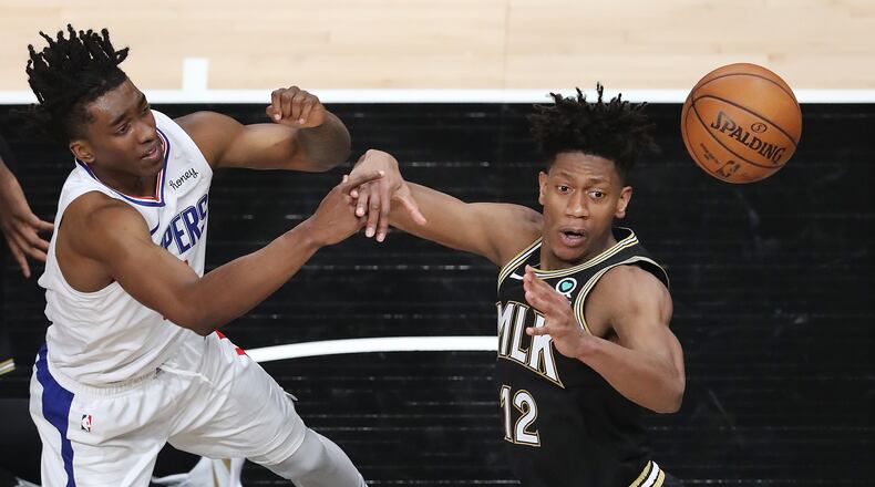 Hawks forward De’Andre Hunter (right) defends against the Los Angeles Clippers' Terance Mann. Curtis Compton / Curtis.Compton@ajc.com”