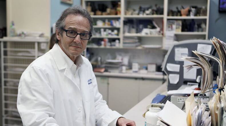 Drugstore owner Ira Katz knew what to do when he saw a young man unconscious in a car in the Little Five Points parking lot outside his pharmacy, which has been in Little Five Points for 37 years. Like Katz, regular citizens armed with Narcan are saving the lives of people who overdose on opioids. BOB ANDRES /BANDRES@AJC.COM