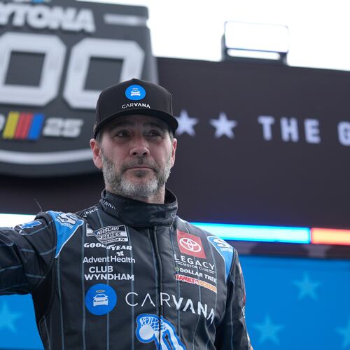 FILE - Jimmie Johnson waves during driver introductions before the NASCAR Daytona 500 auto race at Daytona International Speedway, Feb. 16, 2025, in Daytona Beach, Fla. (AP Photo/John Raoux, File)
