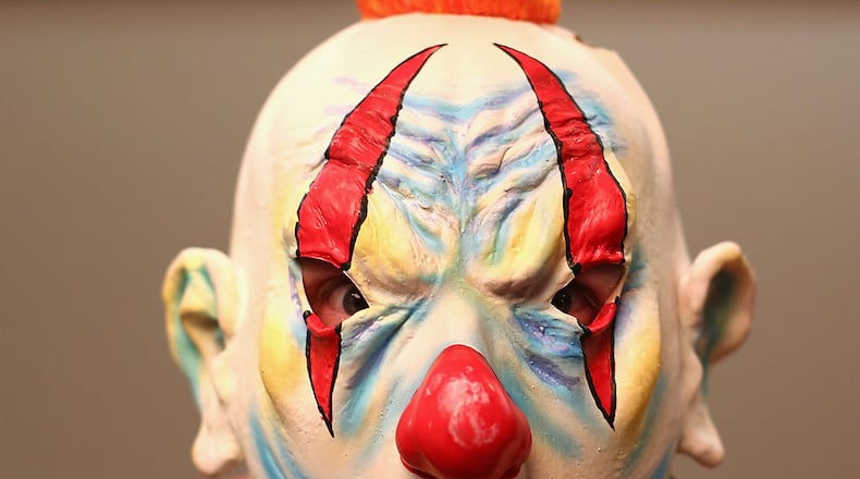 SYDNEY, AUSTRALIA - AUGUST 29: A darts fan in an evil clown mask fancy dress poses as they arrive during the Sydney Darts Masters at Hordern Pavilion on August 29, 2014 in Sydney, Australia. (Photo by Mark Kolbe/Getty Images)