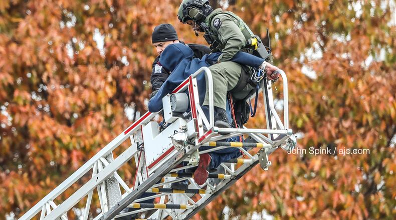 Authorities safely talked a man down from the Boulevard bridge and reopened I-20 in both directions a short time later.