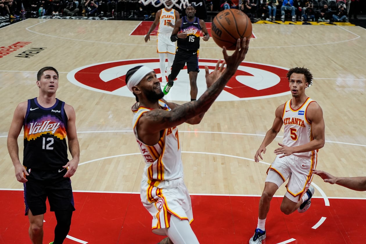 Hawks guard Nickeil Alexander-Walker (center) shoots during second half against the Suns on Friday, Jan. 23, 2026, in Atlanta. The Hawks won 110-103 for their second straight victory. (Mike Stewart/AP)