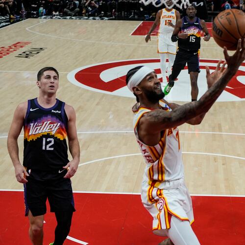 Hawks guard Nickeil Alexander-Walker (center) shoots during second half against the Suns on Friday, Jan. 23, 2026, in Atlanta. The Hawks won 110-103 for their second straight victory. (Mike Stewart/AP)