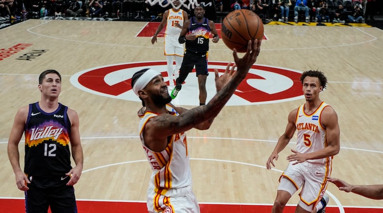 Hawks guard Nickeil Alexander-Walker (center) shoots during second half against the Suns on Friday, Jan. 23, 2026, in Atlanta. The Hawks won 110-103 for their second straight victory. (Mike Stewart/AP)