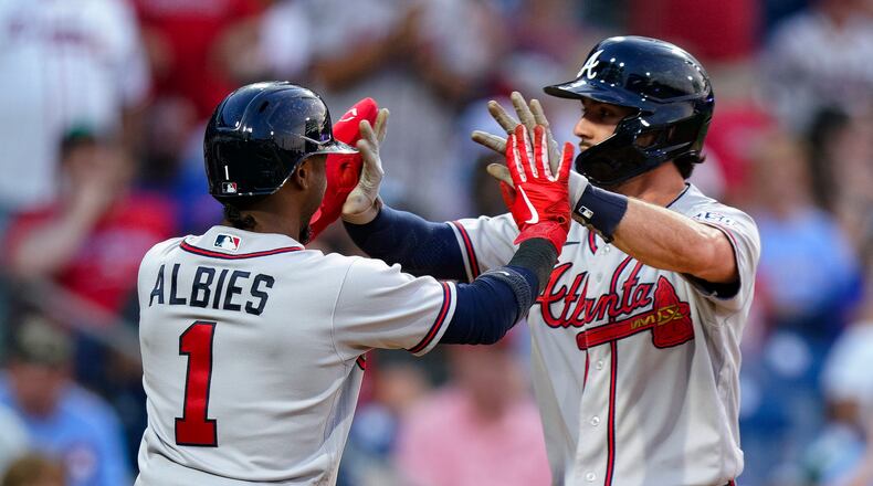 Atlanta Braves' Dansby Swanson, right, celebrates with Ozzie Albies after hitting a grand slam during the third inning of the team's baseball game against the Philadelphia Phillies, Thursday, July 22, 2021, in Philadelphia. (AP Photo/Chris Szagola)
