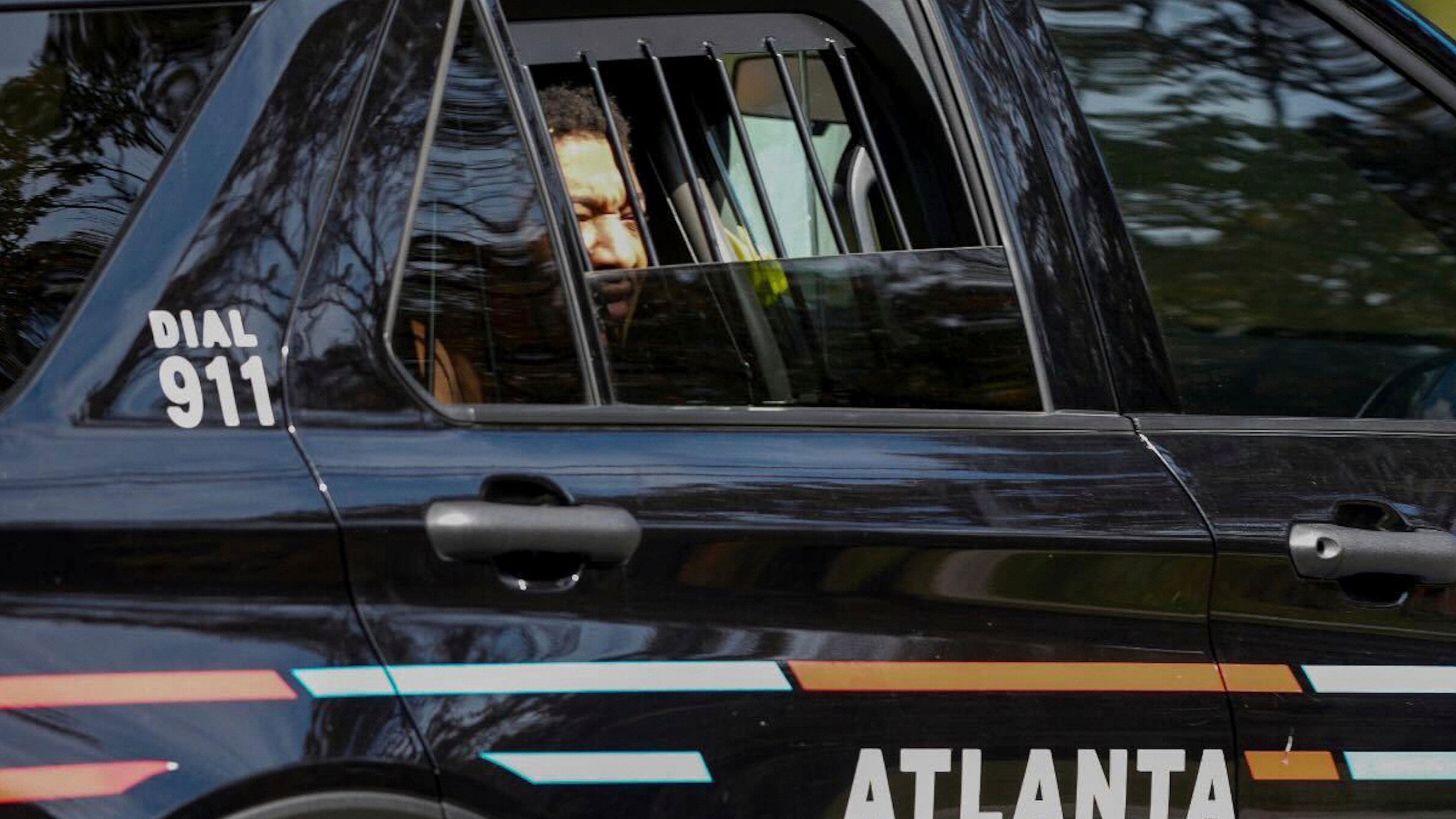 FILE - Derrick Groves sits in a police vehicle after being taken into custody by U.S. Marshals and Atlanta police at a southwest Atlanta home, Oct. 8, 2025. (Ben Hendren/Atlanta Journal-Constitution via AP, file)