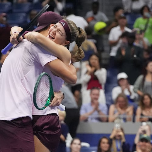 Jakub Mensik, of the Czech Republic, celebrates with Karolina Muchova, right, of the Czech Republic, after they won the mixed doubles final match against Belinda Bencic, of Switzerland, and Flavio Cobolli, of Italy, at the U.S. Open tennis championships Wednesday, Aug. 26, 2026, in New York. (AP Photo/Frank Franklin II)