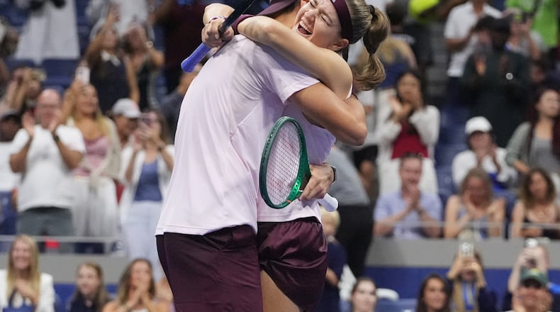 Jakub Mensik, of the Czech Republic, celebrates with Karolina Muchova, right, of the Czech Republic, after they won the mixed doubles final match against Belinda Bencic, of Switzerland, and Flavio Cobolli, of Italy, at the U.S. Open tennis championships Wednesday, Aug. 26, 2026, in New York. (AP Photo/Frank Franklin II)