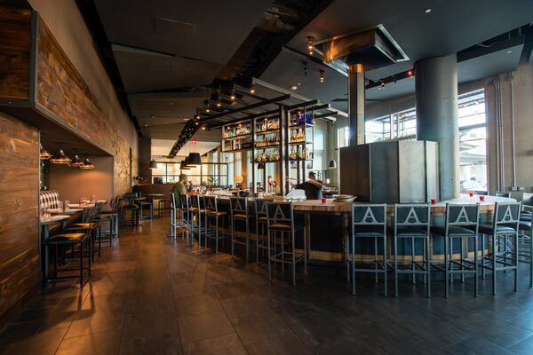 At Allora, the main dining room is divided from a lounge area by a large bar wrapping around the pizza oven. CONTRIBUTED BY HENRI HOLLIS