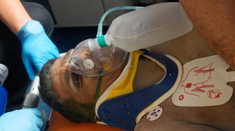 Rescue workers attend to Hernán Alberto Gil Flores after he was pulled from the rubble eight days after he was trapped by twin earthquakes that struck Catia La Mar, Venezuela, Thursday, July 2, 2026. (AP Photo/Fernando Vergara)