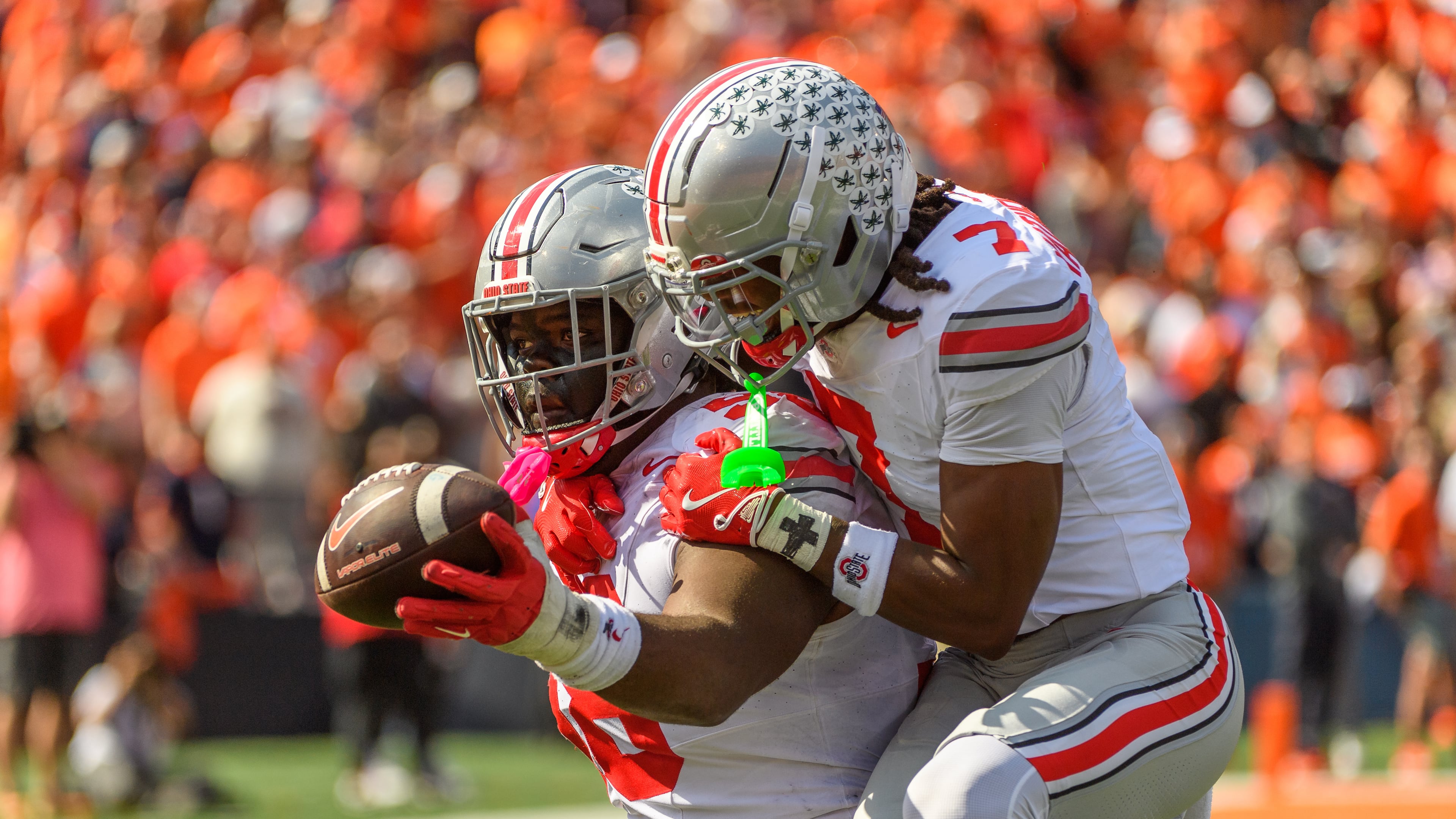 Ohio State defensive lineman Kayden McDonald (98) and cornerback Jermaine Mathews Jr. (7) celebrate a fumble recovery during the first half of an NCAA college football game against Illinois, Saturday, Oct. 11, 2025, in Champaign, Ill. (AP Photo/Craig Pessman)