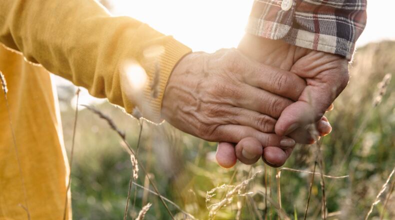 Couple holding hands (stock photo).