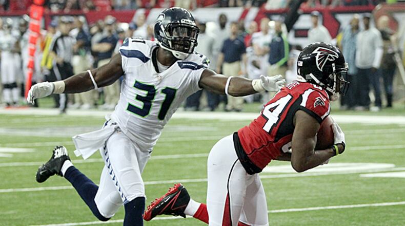011313 ATLANTA : -- RODDY TOUCHDOWN CATCH -- Falcons wide receiver Roddy White catches a touchdown pass in the endzone past Seahawks defender Kam Chancellor for a 20-0 half time lead in their NFL divisional playoff game at the Georgia Dome in Atlanta on Sunday, Jan. 13, 2013. CURTIS COMPTON / CCOMPTON@AJC.COM