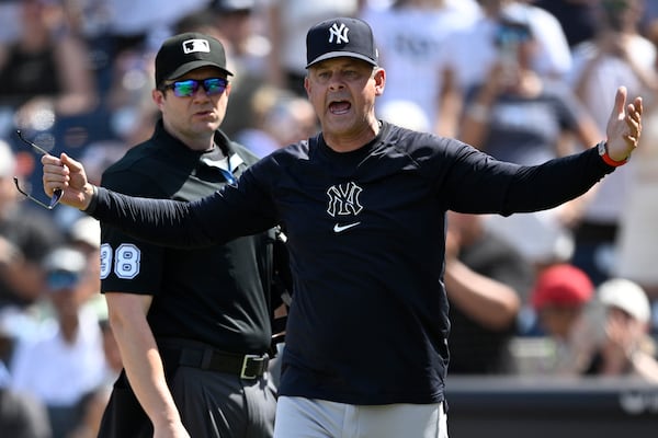 New York Yankees manager Aaron Boone, front, reacts after getting ejected by home plate umpire Adam Beck (38) during the eighth inning of a baseball game against the Tampa Bay Rays, Sunday, April, 20, 2025, in Tampa, Fla. (AP Photo/Phelan M. Ebenhack)