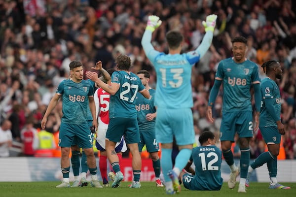Bournemouth players celebrate at the end of the English Premier League soccer match between Arsenal and Bournemouth at Emirates stadium in London, Saturday, May 3, 2025. (AP Photo/Kin Cheung)